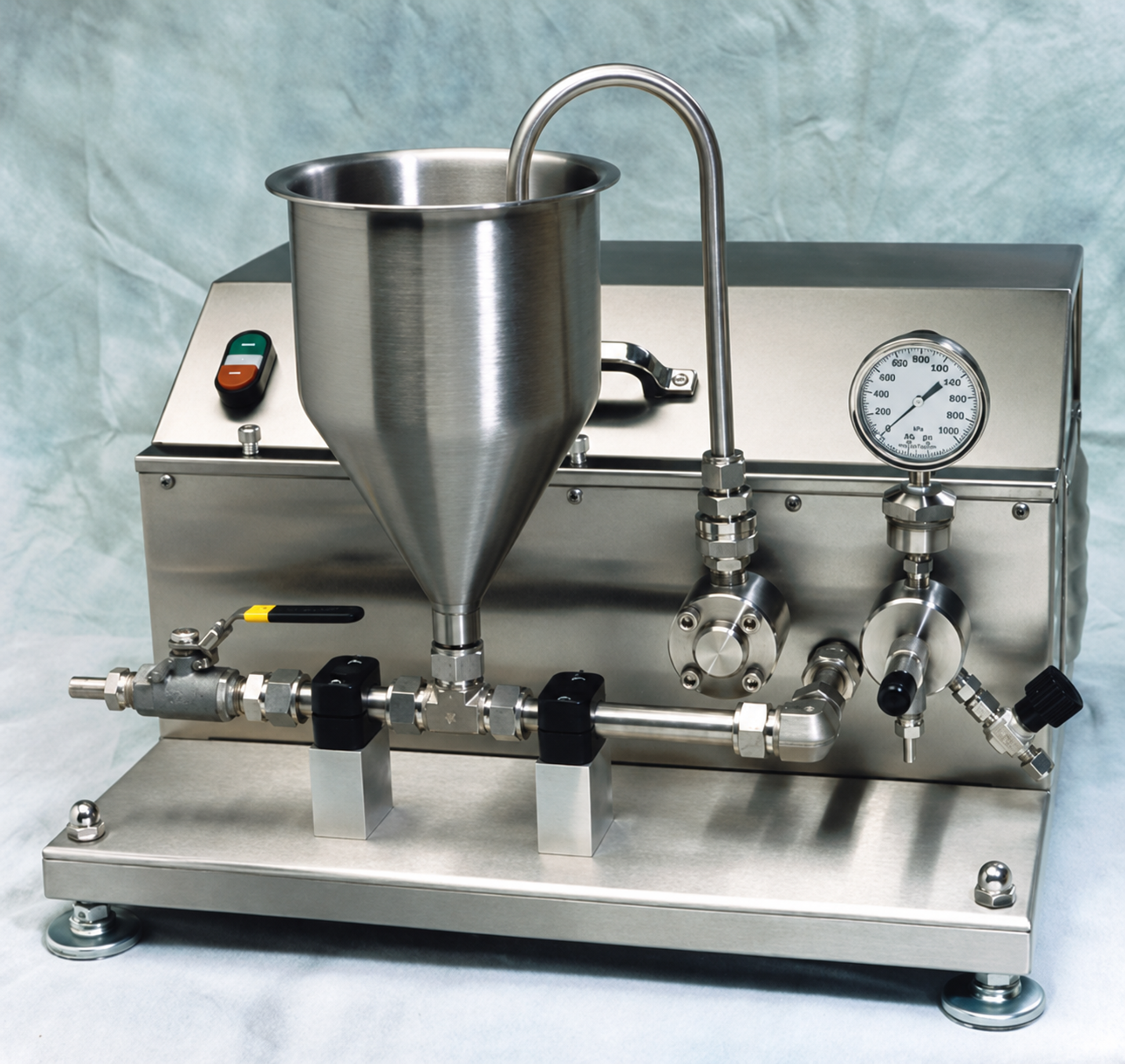 CaviMax 22 bench processor with a stainless-steel feed funnel, recirculation pipe, pressure gauge, valves, and metal base.